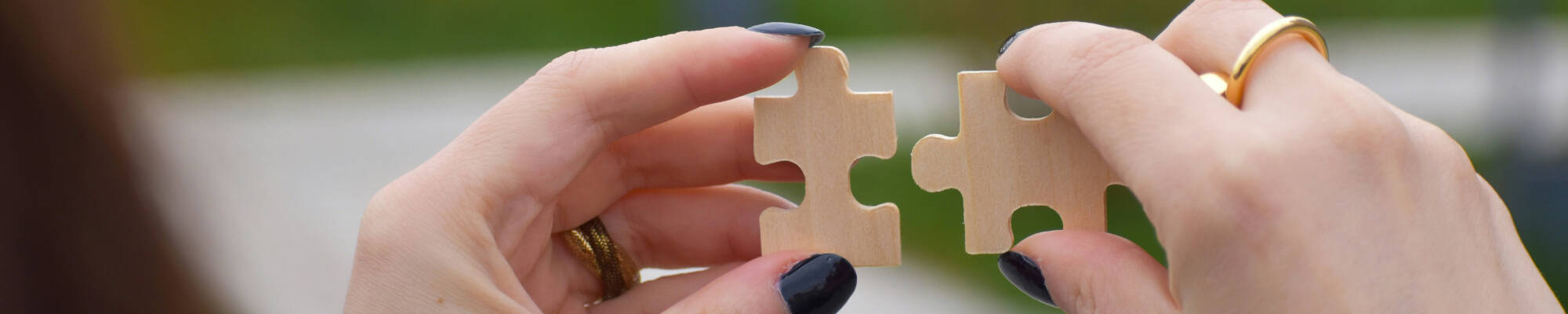 Two hands with matching jigsaw pieces